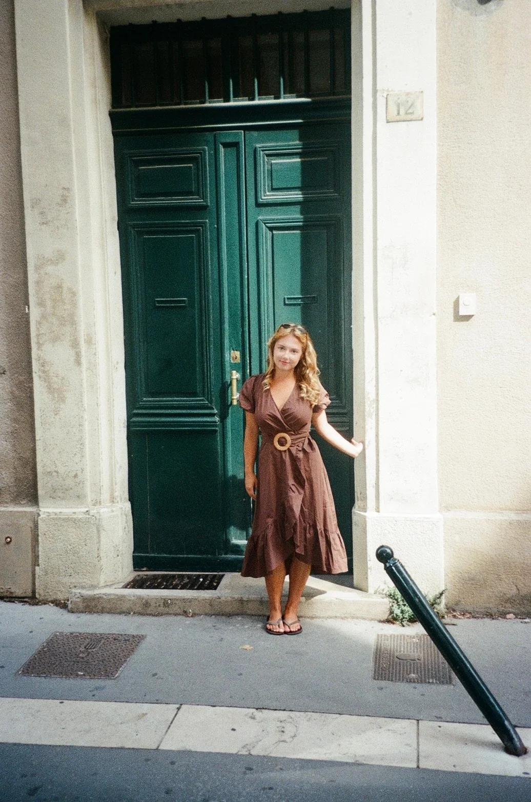 Sydney Lowrey standing in front of a green door in France
